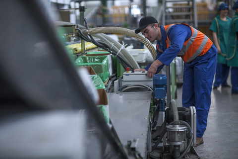 Man working on machine in factory stock photo