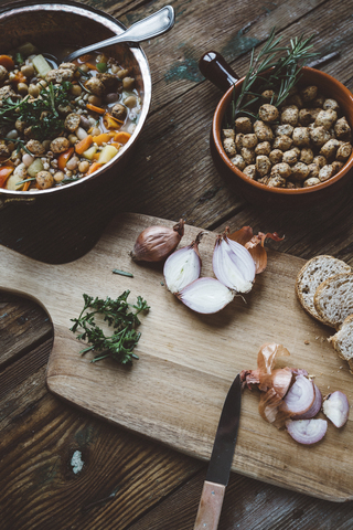 Mediterranean soup in copper pot, bowl of croutons and ingredients on wooden board stock photo