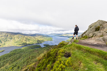 UK, Scotland, Highland, Trossachs, tourist looking from mountain Ben A'an to Loch Katrine - FOF09454