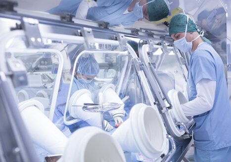 Scientists processing human tissue in insulator laboratory - WESTF23585