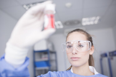 Scientist in lab examining sample - WESTF23617