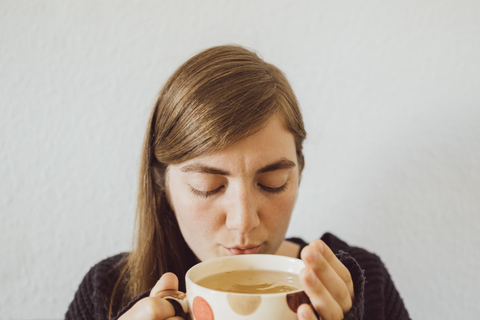 Woman with hot cup of tea stock photo