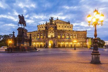 Germany, Dresden, Semper opera house with equestrian statue at blue hour - WDF04189