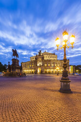 Germany, Dresden, Semper opera house with equestrian statue at blue hour - WDF04190