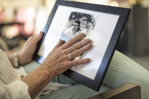 Close-up of senior woman holding a photograph - ZEF14771