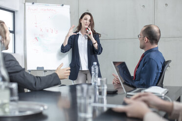 Businesswoman leading a presentation on a meeting in conference room - ZEF14800