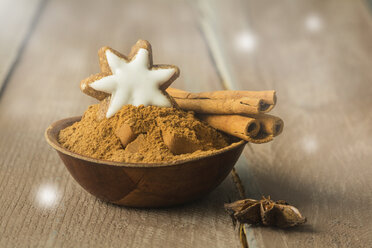 Bowl of cinnamon powder decorated with cinnamon star and cinnamon sticks - ODF01574