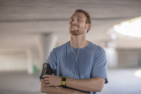 Man exercising and listening to music wearing earphones stock photo