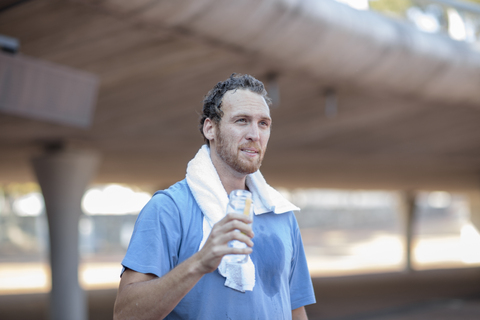 Man having a drink of water after exercising stock photo