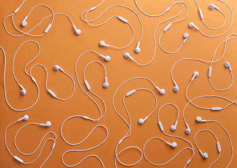 White earphones on orange background, 3D Rendering - DRBF00031