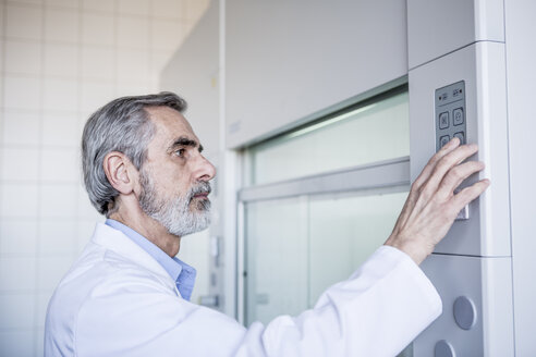 Scientist in lab handling security system - WESTF23771