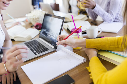 Group of female students working together at table at home - GIOF03374