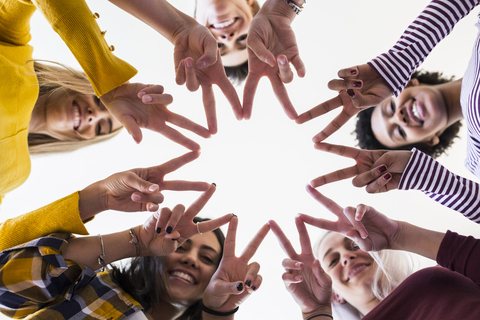Close-up of hands of five women shaping a star stock photo
