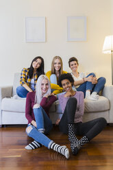 Portrait of group of female friends in living room - GIOF03423