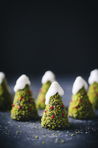 Schokoladenkuchen in Form eines Weihnachtsbaums, verziert mit Pistazien und Glasur, lizenzfreies Stockfoto