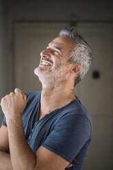 Portrait of laughing mature man at home - ALBF00282