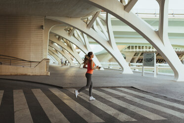 Spain, Valencia, woman running at Ciudad de las Artes y de Las Ciencias - JPF00295