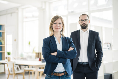 Portrait of confident businesswoman and man in office - JOSF01909