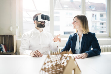 Frau und Mann mit Hausmodell und VR-Brille im Büro - JOSF01912