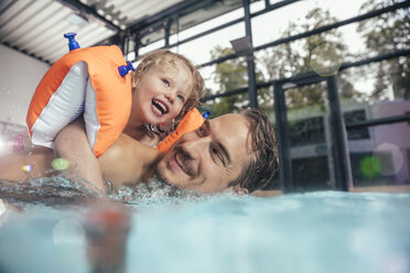 Happy father with daughter in indoor swimming pool - MFF04198