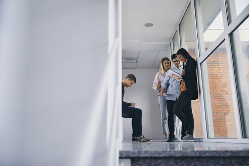 Group of students standing in hallway with documents - ZEDF01024