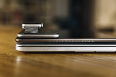 Stack of mobile devices on table top - MFF04222