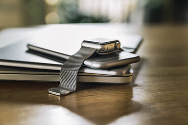 Stack of mobile devices on table top - MFF04224