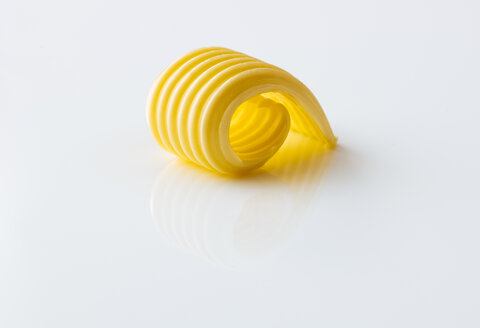 Curl of butter on white ground - PPXF00137