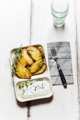 Bowl of potato wedges with rosemary and herbed curd cheese - SBDF03391