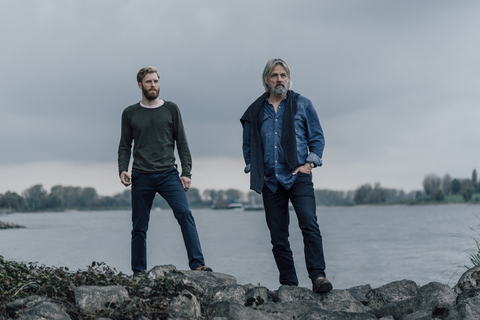 Father and son meeting at Rhine river in autmn, talking together stock photo