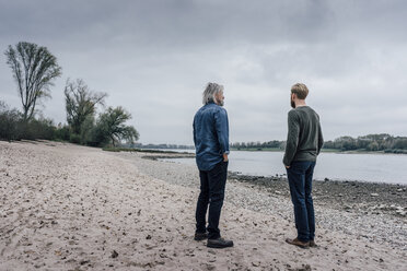 Father and son taking a stroll at Rhine river, meeting to talk - KNSF02912