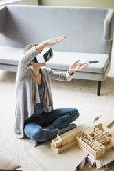 Frau im Büro mit Architekturmodell und VR-Brille - JOSF01967