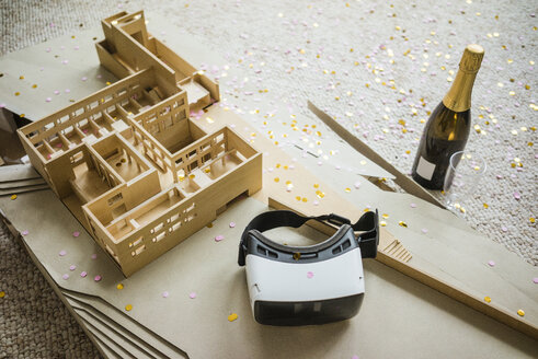 Still life with architectural model, confetti, bottle of champagne and VR glasses - JOSF01969