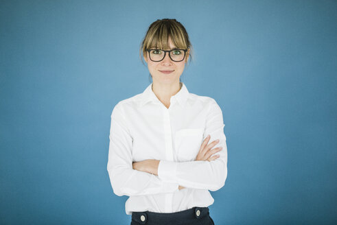 Portrait of smiling businesswoman with glasses - JOSF01973