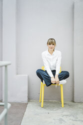 Portrait of woman sitting on a chair - JOSF01980