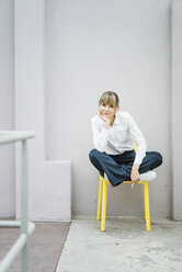 Portrait of woman sitting on a chair - JOSF01981