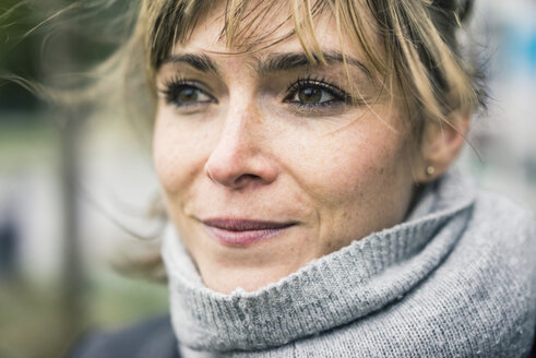 Portrait of smiling woman with scarf outdoors - JOSF02008