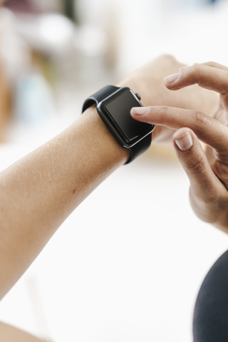 Close-up of woman adjusting her smartwatch stock photo