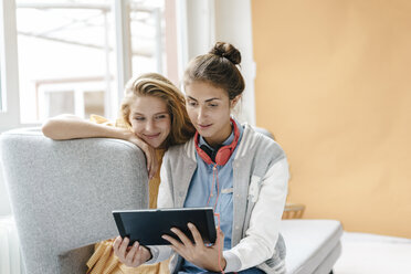 Two young women using tablet - KNSF03034