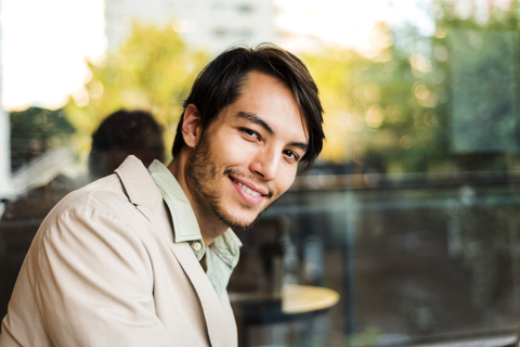 Portrait of smiling young man outdoors stock photo