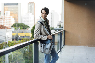 Young man standing on urban balcony - VABF01371