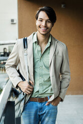 Portrait of smiling young man on balcony - VABF01376