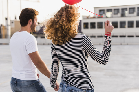 Back view of young couple at sunset stock photo