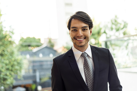 Portrait of smiling businessman outdoors stock photo