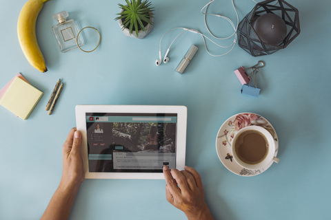 Business desk from above, hands using tablet stock photo