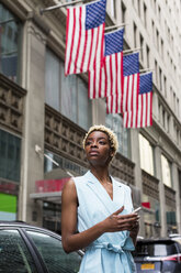 USA, New York, junge blonde afro-amerikanische Frau mit Smartphone - MAUF01250