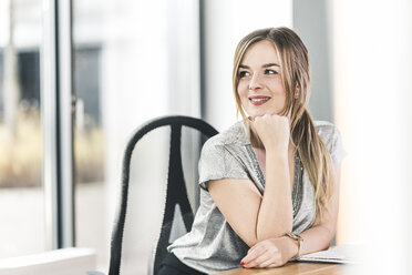 Smiling businesswoman at desk in office - UUF12402