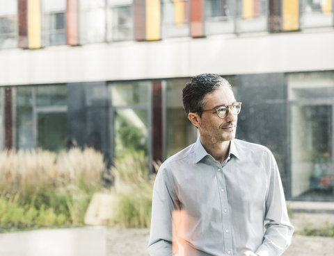 Smiling businessman at the window stock photo