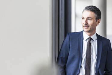 Portrait of smiling businessman in office - UUF12417