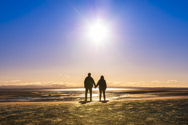 Great Britain, Scotland, Solway Firth, silhouette of mature couple, hand in hand - SMAF00875